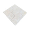 A grid of twelve light-colored Crema Marfil 4X4 Tumbled natural stone tiles with subtle variations