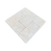 A grid of twelve light-colored Crema Marfil 4X4 Tumbled natural stone tiles with subtle variations
