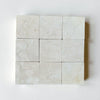 Crema Marfil 4X4 Tumbled light-colored marble tiles with natural veining