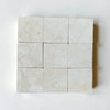 Crema Marfil 4X4 Tumbled light-colored marble tiles with natural veining
