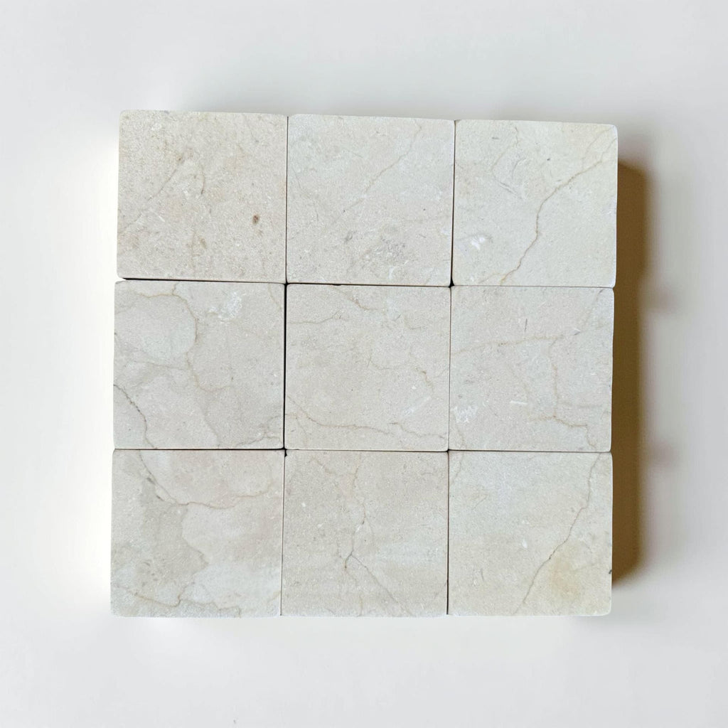 Crema Marfil 4X4 Tumbled light-colored marble tiles with natural veining