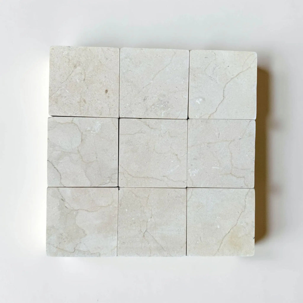 Crema Marfil 4X4 Tumbled light-colored marble tiles with natural veining