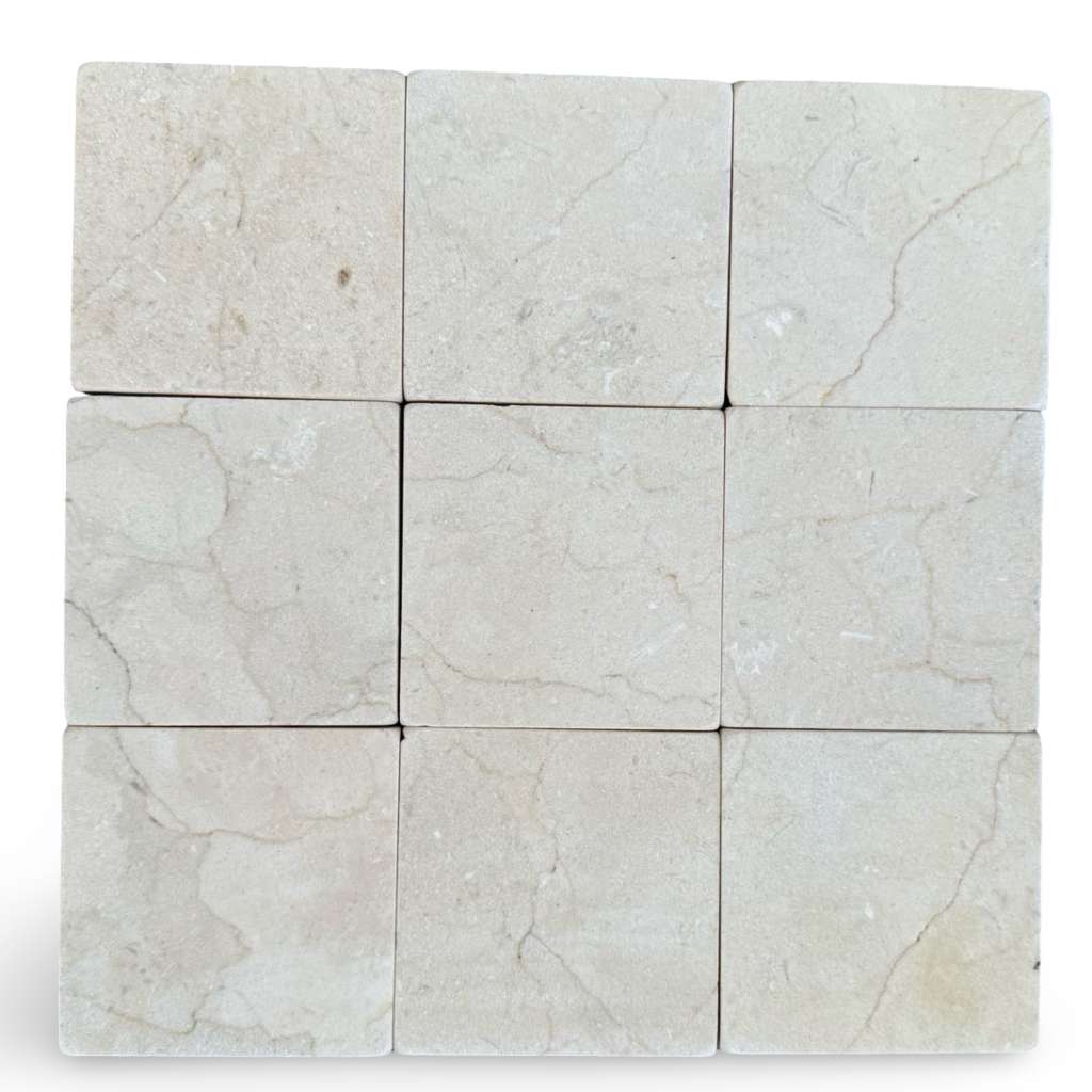 Light beige Crema Marfil 4x4 tumbled marble tiles with subtle veining patterns
