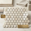 Hexagonal crema marfil marble tiles with subtle veining in polished or honed finish arranged in modern mosaic design