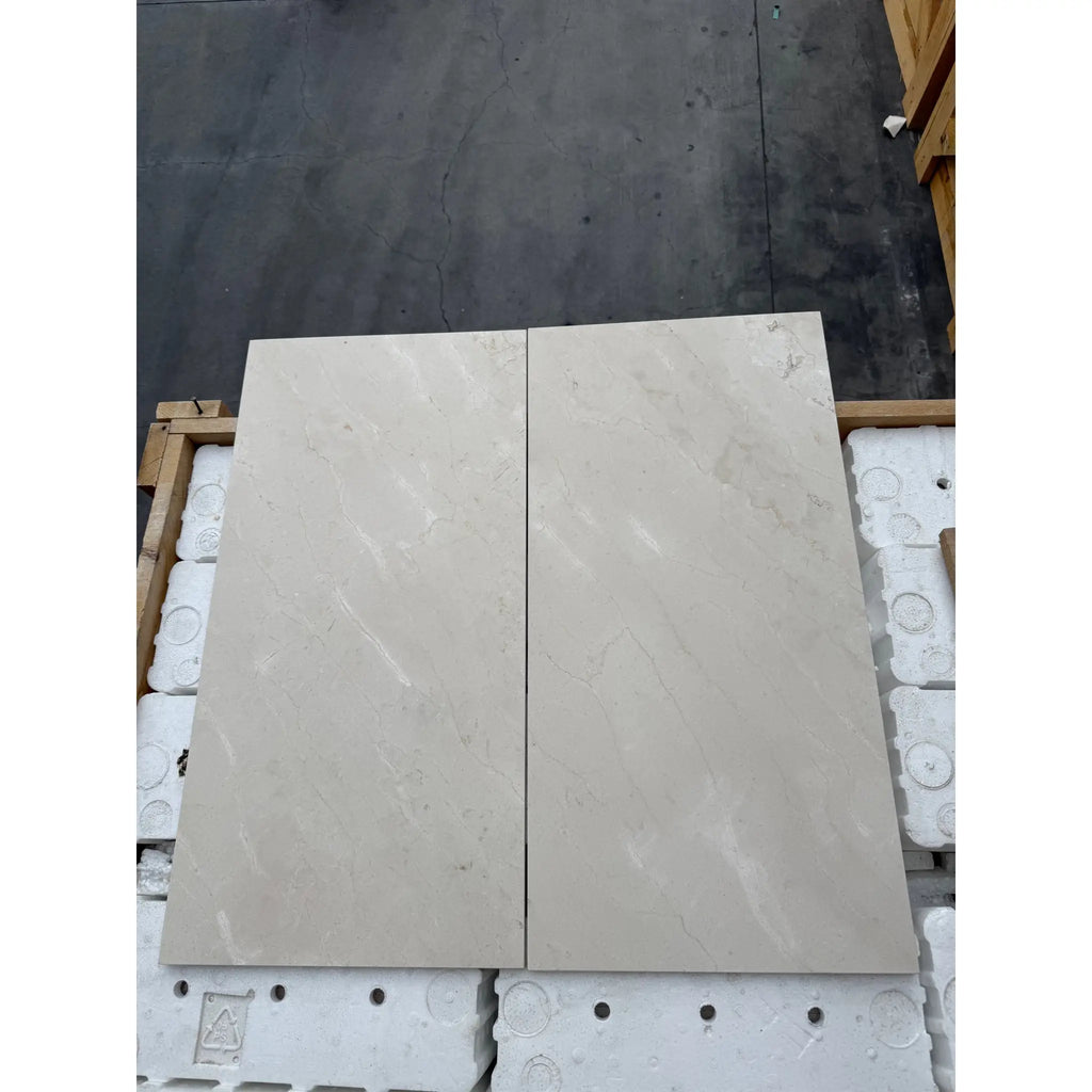 Two light-colored Crema Marfil Marble 12x24 tiles polished or honed for flooring