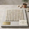 Crema Marfil marble 1x1 mosaic polished or honed square tile panel in creamy beige with subtle veining on stone slab