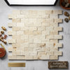 Beige rectangular Crema Marfil marble brick mosaic tiles with natural veining and rustic textured split-faced finish