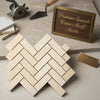 Crema marfil marble 1x3 polished cream-colored spanish crema marfil tiles arranged in a herringbone mosaic pattern