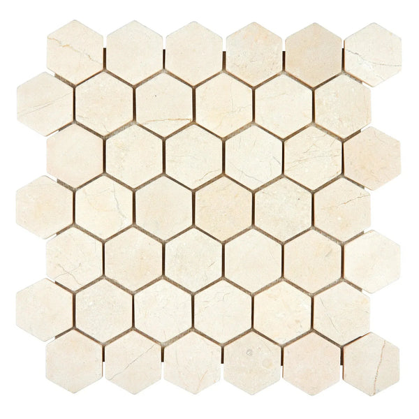 Beige hexagonal tile mosaic of Crema Marfil Marble 2 inch Tumbled Hexagon Mosaic