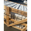 Rustic wooden crate stamped Made in Spain holds stacked Crema Marfil Marble 24x24 panels