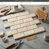 Beige crema marfil marble 2x4 deep beveled mosaic tiles arranged in a polished-honed brick pattern