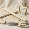 Cream-colored Crema Marfil marble tiles with subtle veining and polished finish displayed with matching bullnose slab
