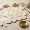 Beige crema marfil marble hexagon mosaic tiles polished or honed arranged in a honeycomb pattern
