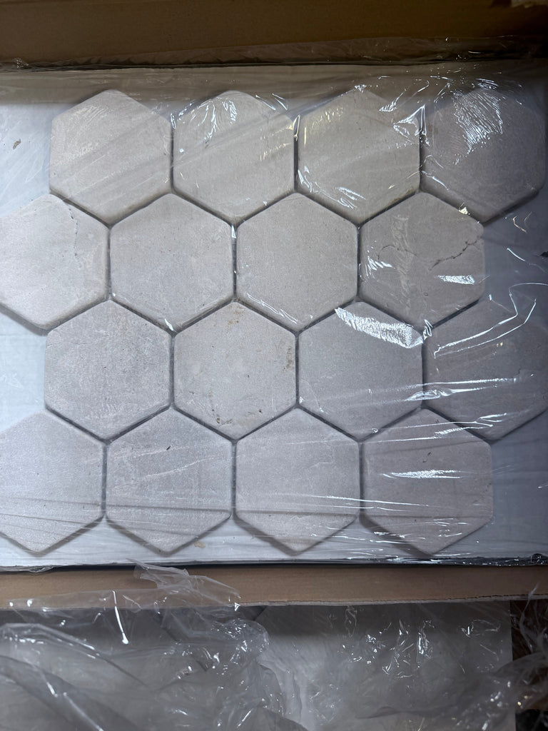 Crema Marfil Marble 3-inch tumbled hexagon mosaic in light gray matte finish