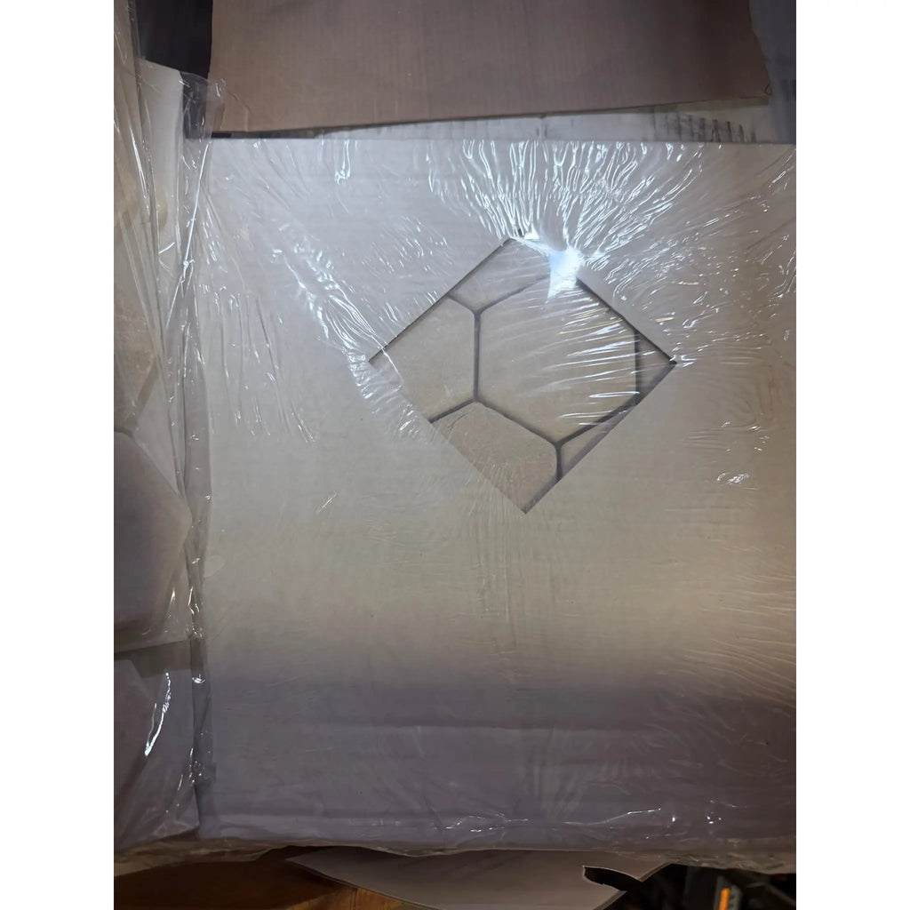 White plastic-wrapped box with black cutout, Crema Marfil tumbled hexagon mosaic