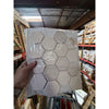 Crema Marfil Marble 3-inch hexagon mosaic tumbled tile panel in clear plastic