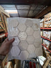 Crema Marfil Marble 3-inch hexagon mosaic tumbled tile panel in clear plastic