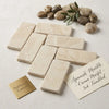 Cream-colored Crema Marfil marble 3x6 tiles with subtle veining and a tumbled finish for elegant surfaces