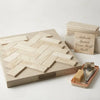 Beige crema marfil marble 4x12 polished or honed tiles arranged in a herringbone pattern on a display board