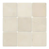 Nine off-white Crema Marfil Marble 4X4 Tumbled tiles arranged in a square pattern