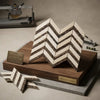 Crema marfil marble chevron large mosaic tile in cream and dark brown tones displayed on a wooden base