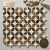 Elegant crema marfil marble tile panel with interlocking oval and diamond shapes in warm brown and creamy beige tones