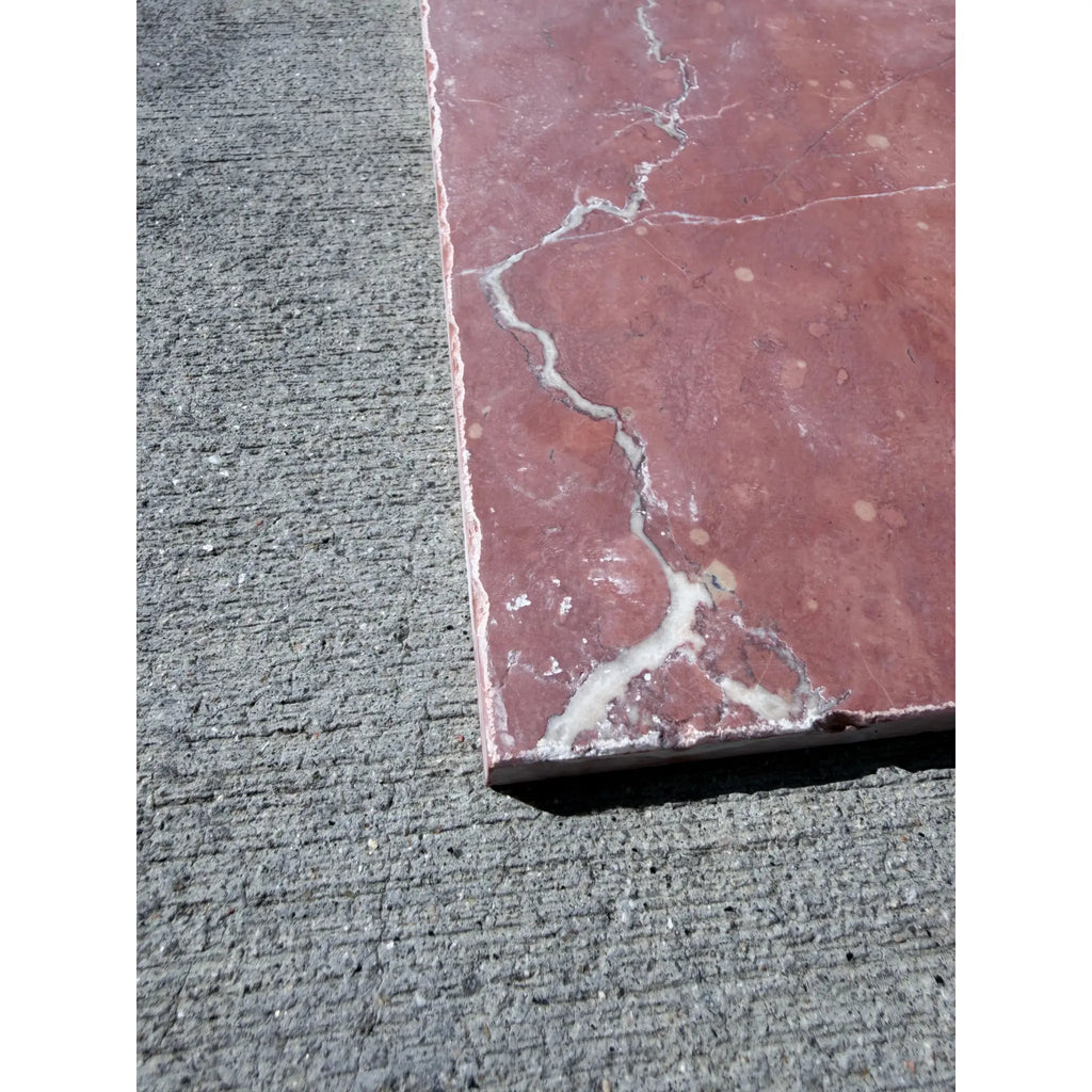 Crema Marrfil Rustic Modern Tumbled reddish-pink marble tile with white veining on gray concrete