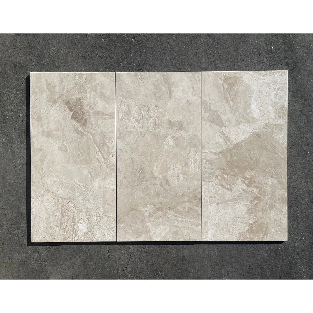 Three rectangular beige polished or honed Diano Royal Queen Beige marble tiles with subtle gray and tan veining