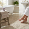 Diano Royal queen beige marble 5/8x5/8 polished mosaic tile bath mat with a subtle grid pattern