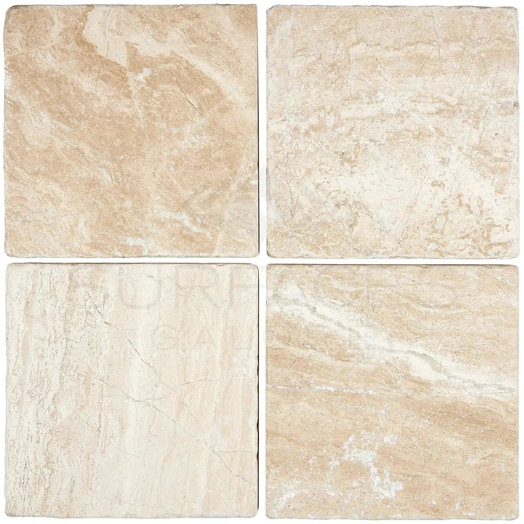 Four beige Diano Royal Marble 6X6 Tumbled tiles arranged elegantly