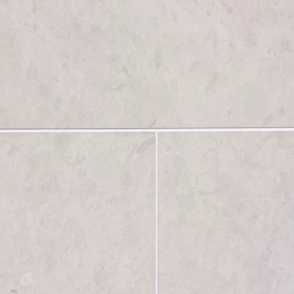 Light gray Dolce Crema 18x18 limestone marble-effect floor tiles with subtle veining and white grout