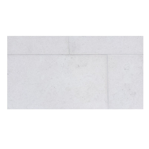 Dolce Ivory 12x12 limestone tiles with white rectangular speckled texture and natural veining