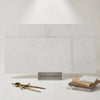 Dolce Ivory 12x24 limestone light gray textured rectangular tiles with subtle speckles in a modern minimalist layout