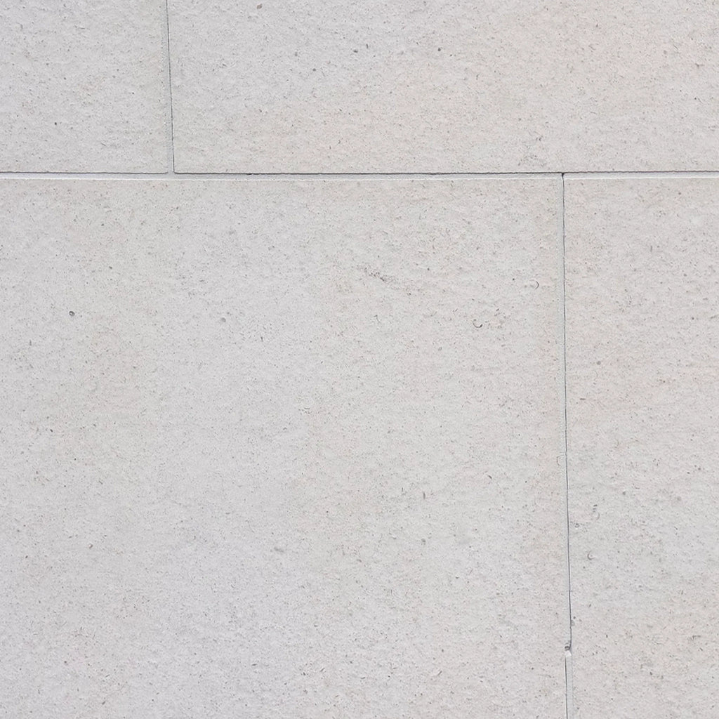 Dolce Ivory 16x16 limestone tiles in light gray textured stone with speckles