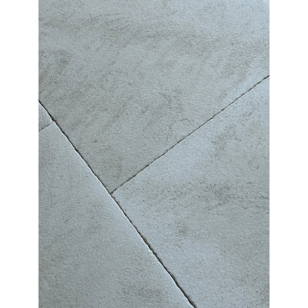 Dolce Ivory 18x18 limestone gray concrete tiles with textured surface and grout lines