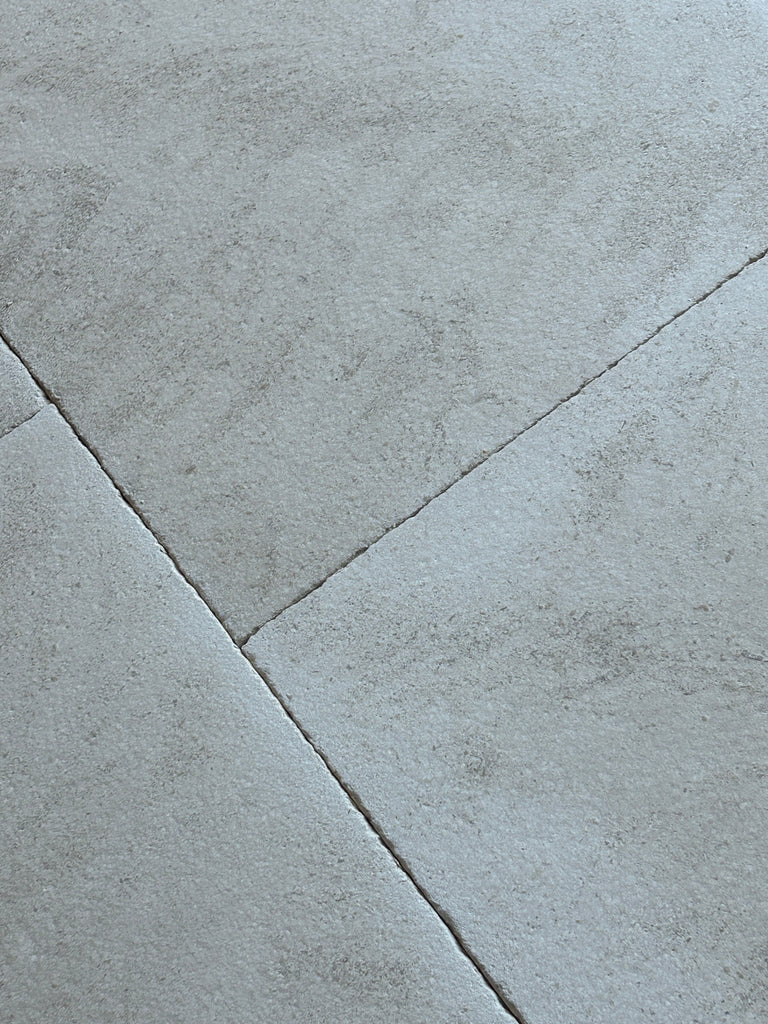 Dolce Ivory 18x18 limestone gray concrete tiles with textured surface and grout lines
