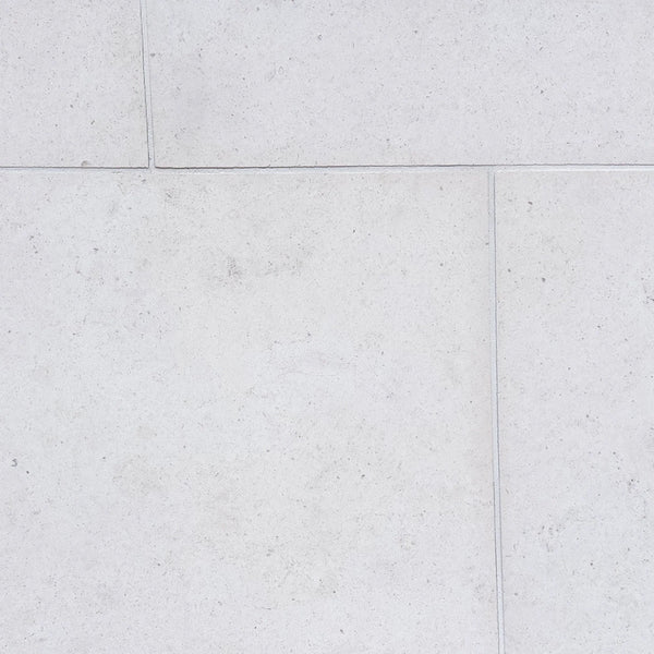 Dolce Ivory 18x36 limestone tiles with white textured stone and subtle gray veining
