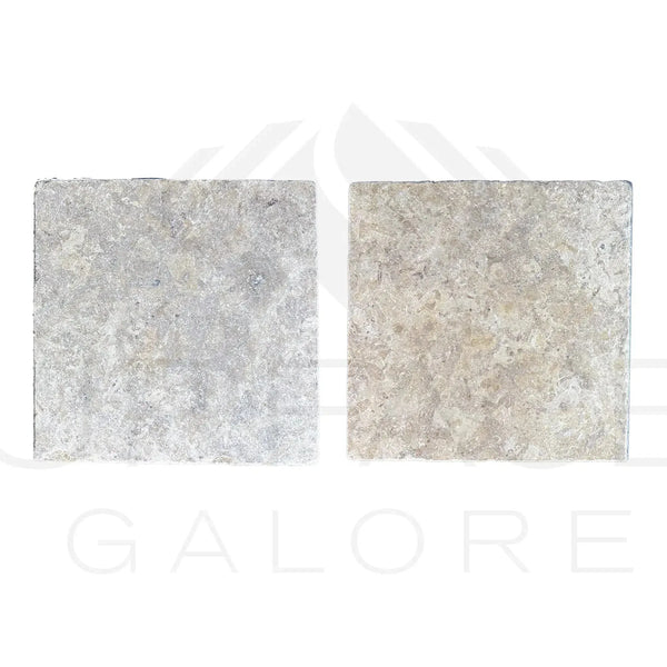 Two square textured stone tiles from Dore Reale Light Golden Beige Tumbled Tile