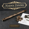 A polished emperador dark marble pencil liner with swirling golden veining shown with raw stones and design schematics