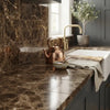 Copper teapot with hammered finish and curved handle displayed on emperador dark marble 12x12 polished surface