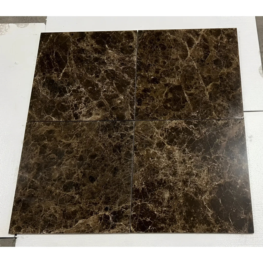 Four polished Emperador Dark Marble tiles with intricate light brown and white veining