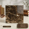 A square slab of polished Emperador Dark marble with a rich dark brown base and intricate golden veining 18x18 inches