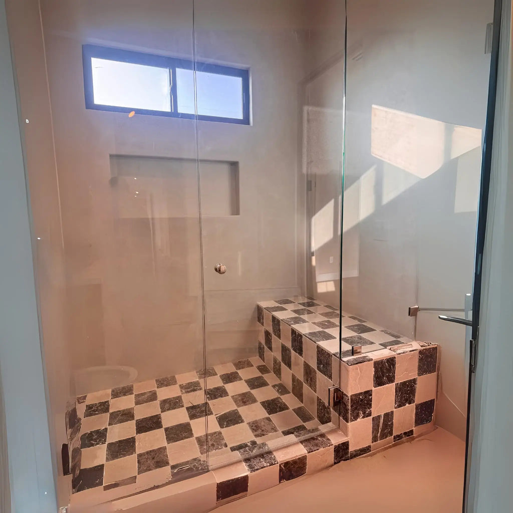 Checkered tile shower with glass enclosure featuring Emperador Dark Marble 1X1 Mosaic Tumbled