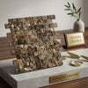 A stacked arrangement of Emperador dark marble 1x2 brick mosaic split-faced tiles in brown and beige with natural veining displayed on a concrete pedestal