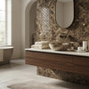 A sleek oval mirror with a brushed brass frame above a vanity featuring emperador dark marble 1x2 herringbone mosaic polished