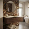 Round gold-framed mirror above dark wood vanity with emperador dark marble 1x4 herringbone mosaic polished backsplash