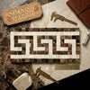 A rectangular emperador dark marble mosaic tile panel with cream brown and black geometric greek key border pattern