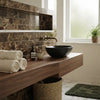 Black ceramic bowl sink featuring emperador dark marble 3x6 polished tiles for a sleek, modern bathroom design