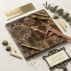 Emperador dark marble slab featuring brown and gold veins with a 4x4 tumbled finish for elegant surfaces