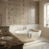 Free-standing white freestanding bathtub with sleek oval design and polished chrome faucet in Emperador dark marble mosaic